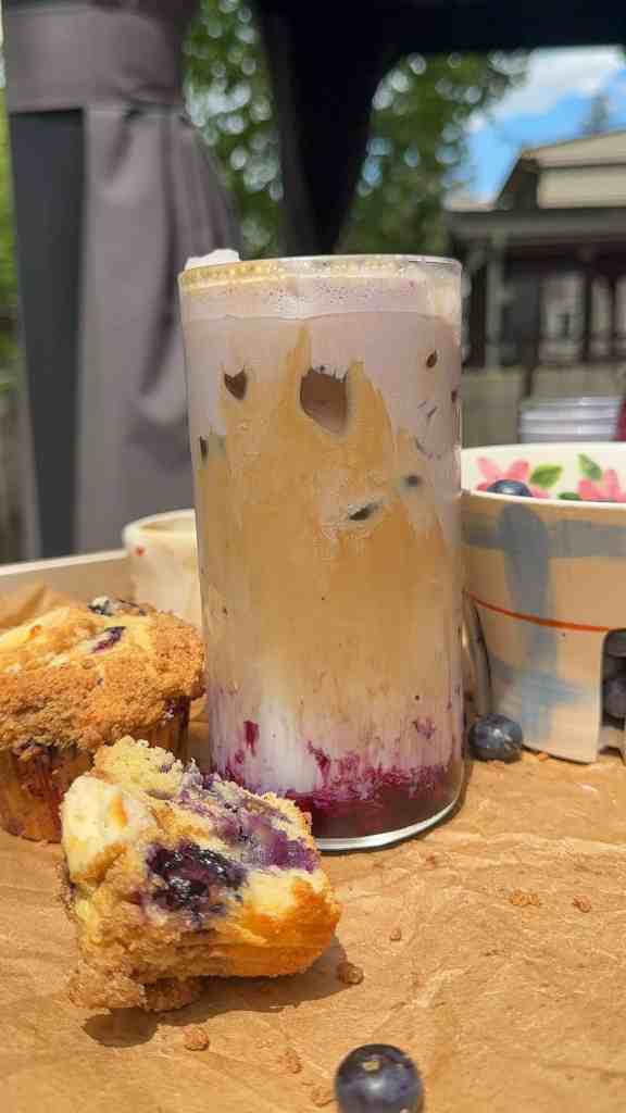 my blueberry latte on parchment paper with blueberries and blueberry muffins
