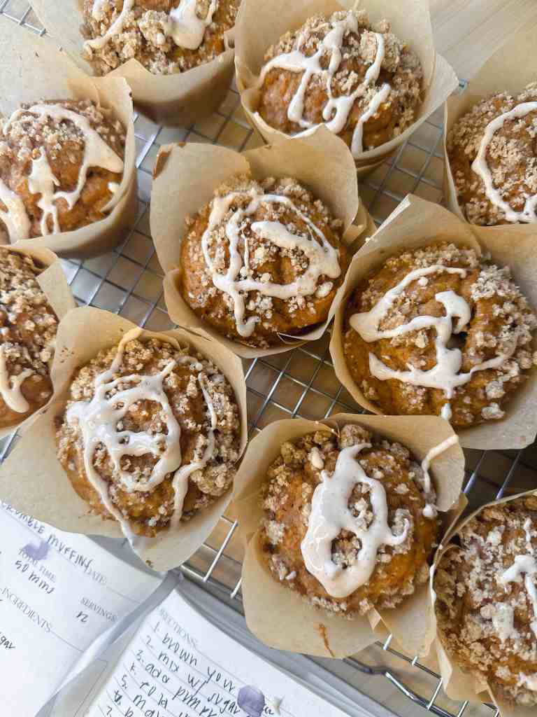 A batch of freshly baked pumpkin muffins cooling on a wire rack, ready to be served.
