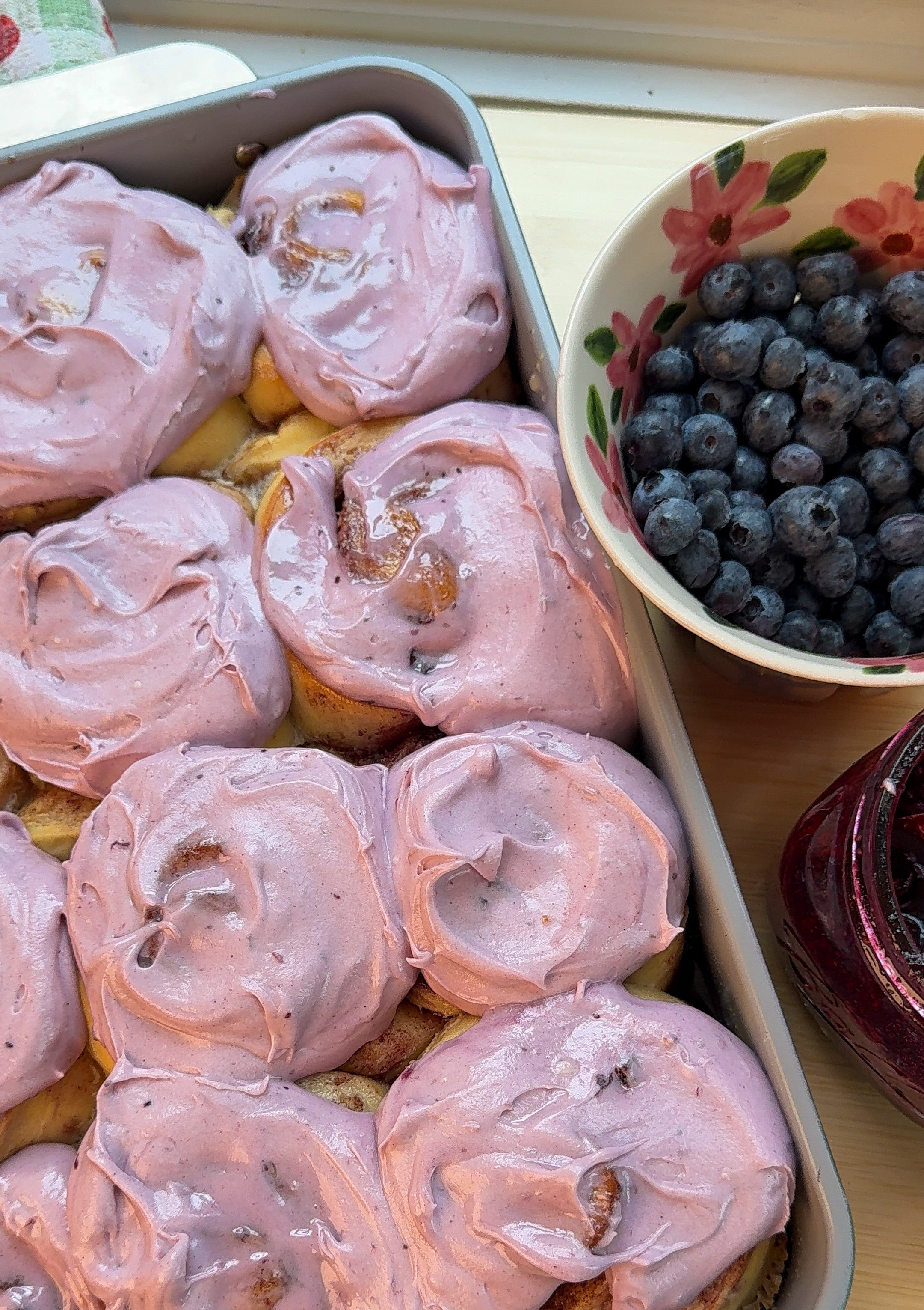 my blueberry cinnamon rolls fresh out of the oven with homemade blueberry cream cheese frosting