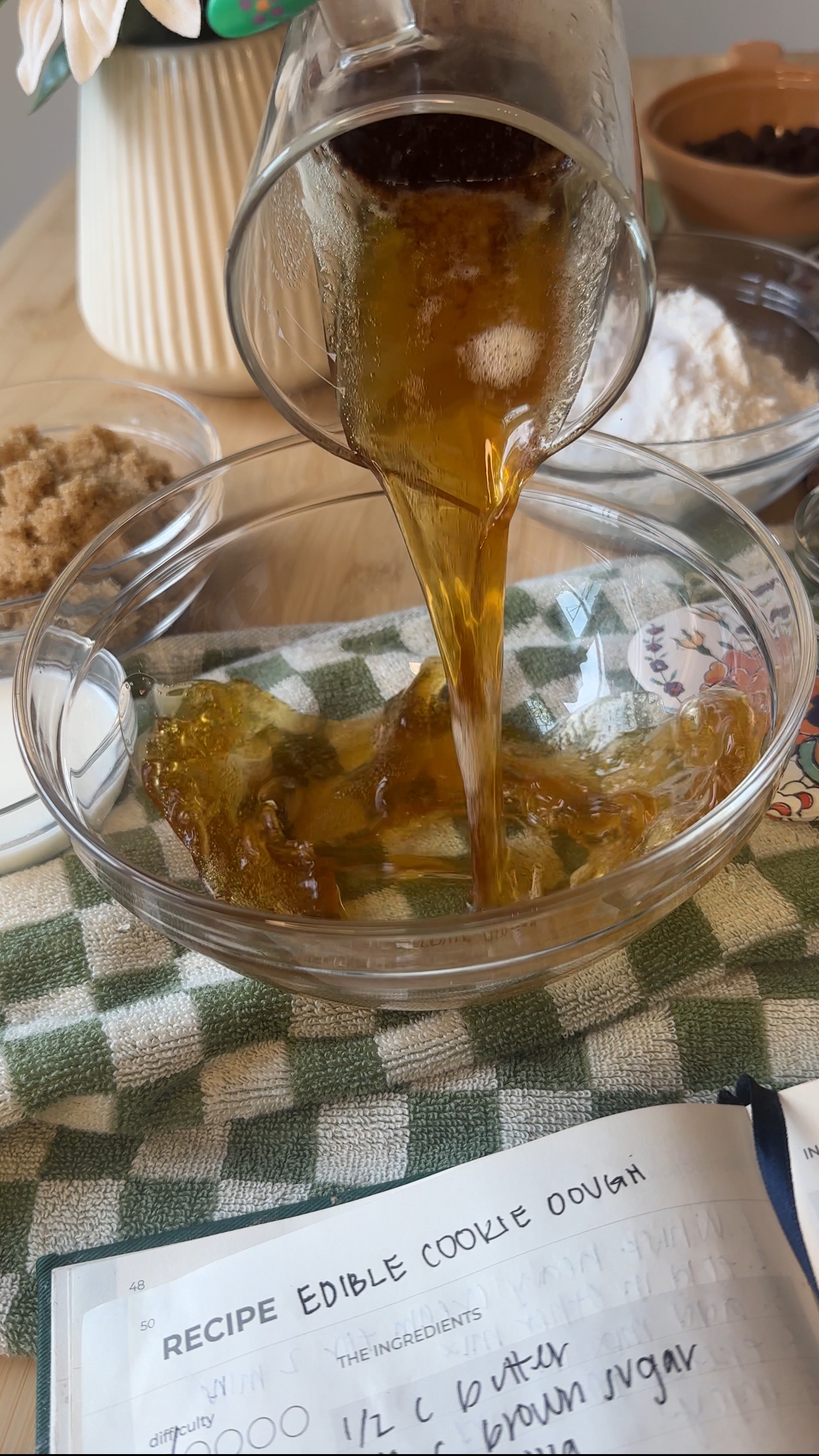 pouring warm brown butter into a clear mixing bowl