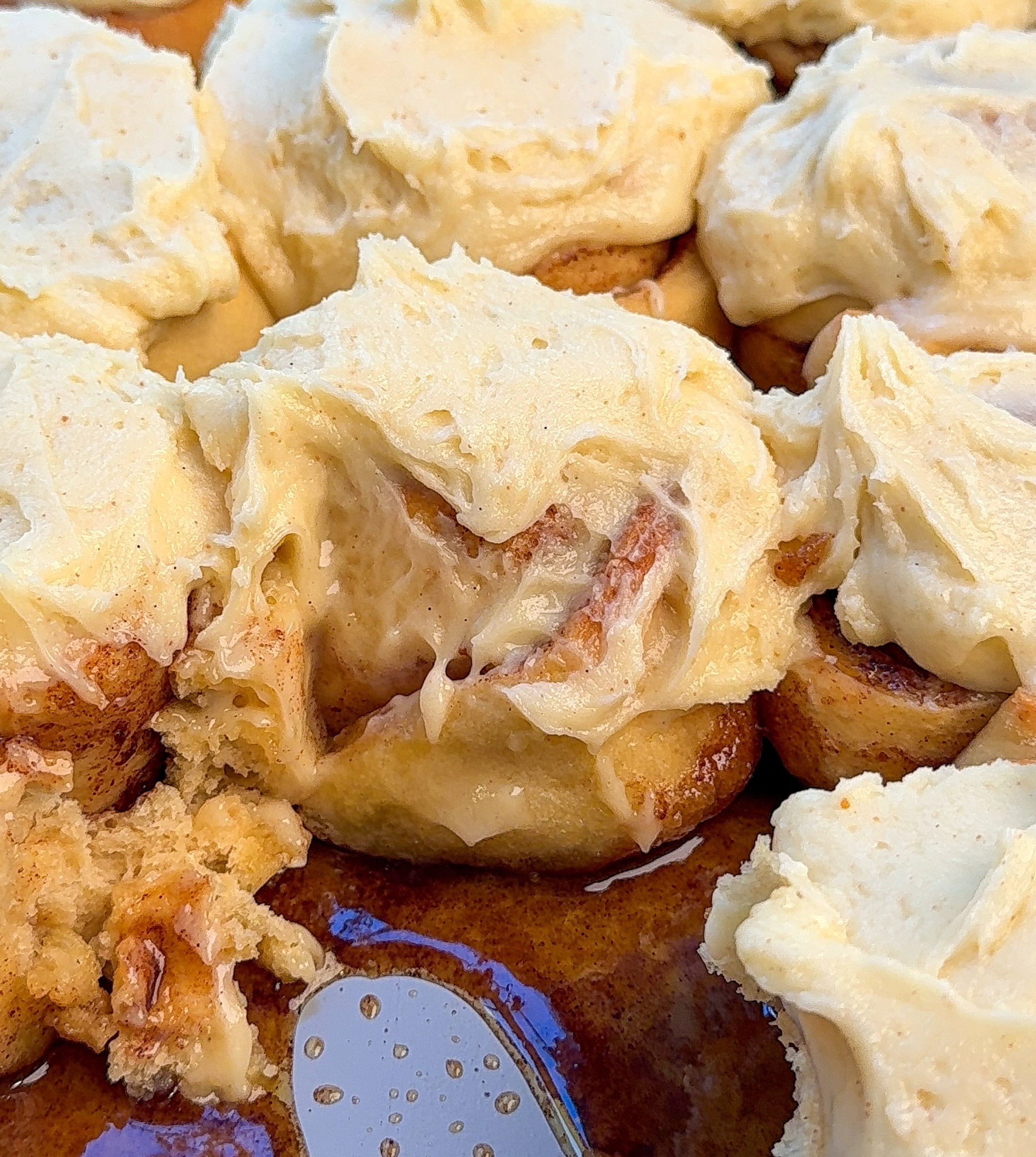 my gooey brown butter cinnamon rolls in a pan with brown sugar at the bottom