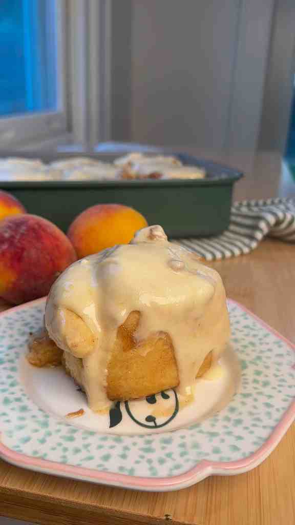 my peach cobbler cinnamon rolls on a plate ready to be enjoyed